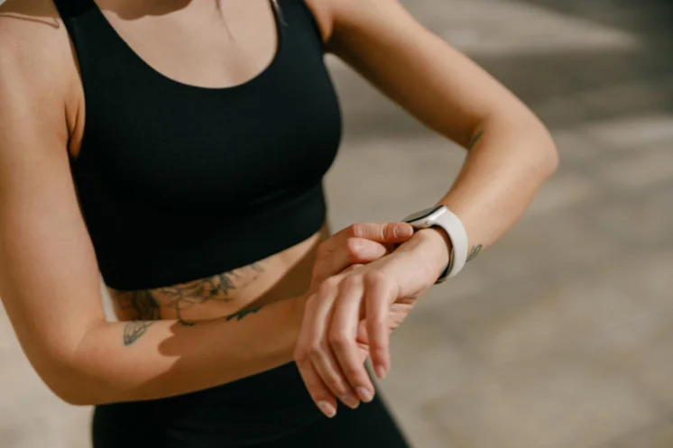 Close-up of a woman checking the fitness band on her wrist